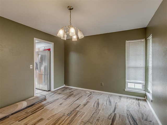 3700 N Edgewater Dr, Oklahoma City, OK 73116 - spare room featuring a chandelier, light wood-style floors, and healthy amount of natural light