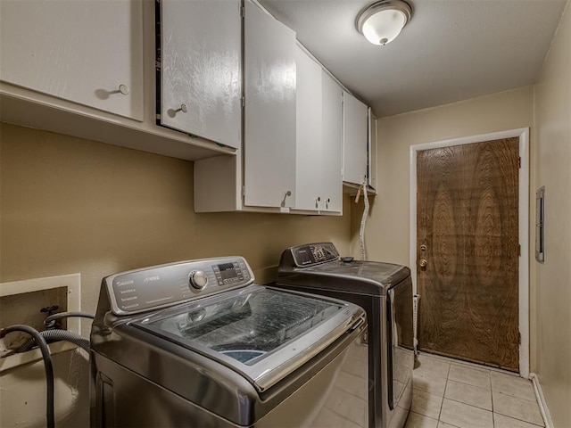 3700 N Edgewater Dr, Oklahoma City, OK 73116 - washroom featuring cabinet space, washing machine and dryer, and light tile patterned floors