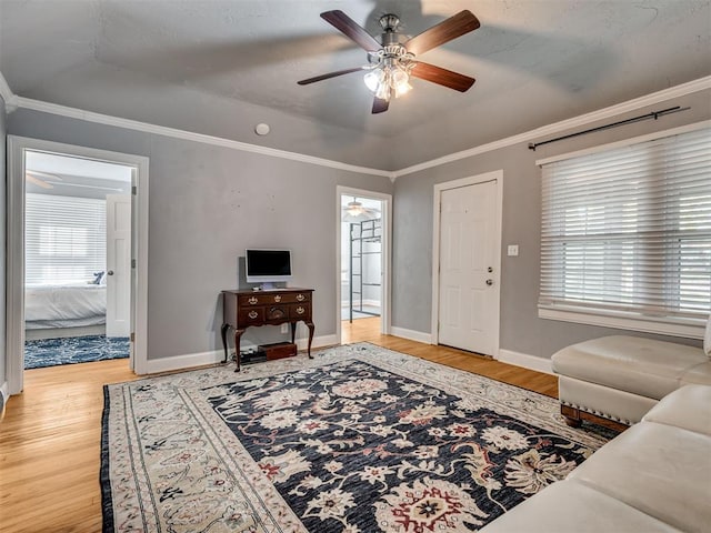 531 NW 48th St, Oklahoma City, OK 73118 - living room with ceiling fan, wood finished floors, crown molding, and healthy amount of natural light