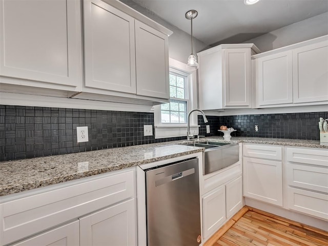 531 NW 48th St, Oklahoma City, OK 73118 - kitchen featuring stainless steel dishwasher, white cabinets, light wood finished floors, decorative backsplash, and light stone countertops