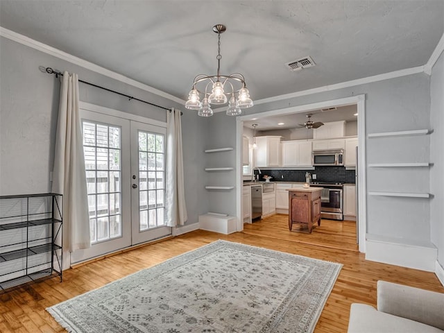 531 NW 48th St, Oklahoma City, OK 73118 - living area featuring french doors, crown molding, a chandelier, light wood-style floors, and ceiling fan