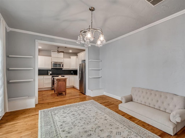 531 NW 48th St, Oklahoma City, OK 73118 - sitting room featuring crown molding, light wood-type flooring, and a chandelier