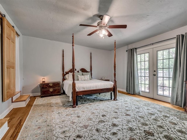 531 NW 48th St, Oklahoma City, OK 73118 - bedroom featuring access to outside, wood finished floors, french doors, and a ceiling fan