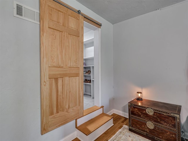 531 NW 48th St, Oklahoma City, OK 73118 - bedroom featuring wood finished floors and a barn door