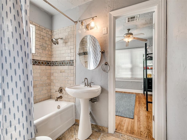 531 NW 48th St, Oklahoma City, OK 73118 - bathroom with shower / tub combo, a ceiling fan, and wood finished floors