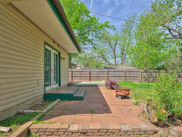 531 NW 48th St, Oklahoma City, OK 73118 - fenced backyard featuring french doors, an outdoor fire pit, and a patio area