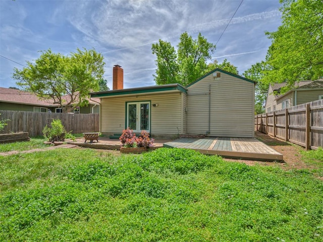 531 NW 48th St, Oklahoma City, OK 73118 - rear view of property featuring french doors, a chimney, a wooden deck, and a fenced backyard