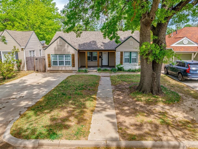 531 NW 48th St, Oklahoma City, OK 73118 - bungalow-style house featuring covered porch, a shingled roof, and concrete driveway