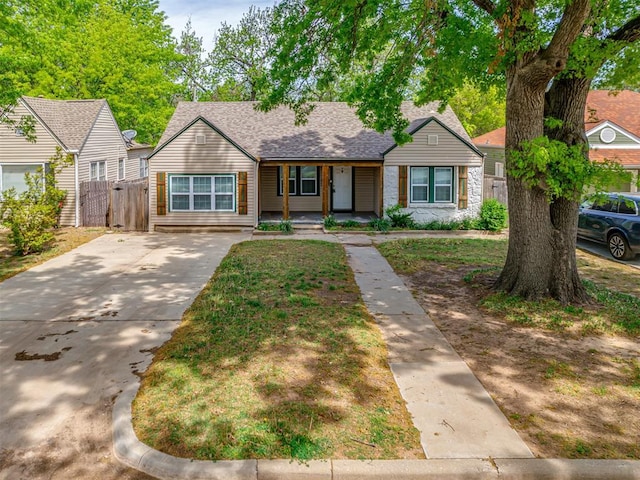 531 NW 48th St, Oklahoma City, OK 73118 - bungalow with a porch, concrete driveway, a gate, and a shingled roof