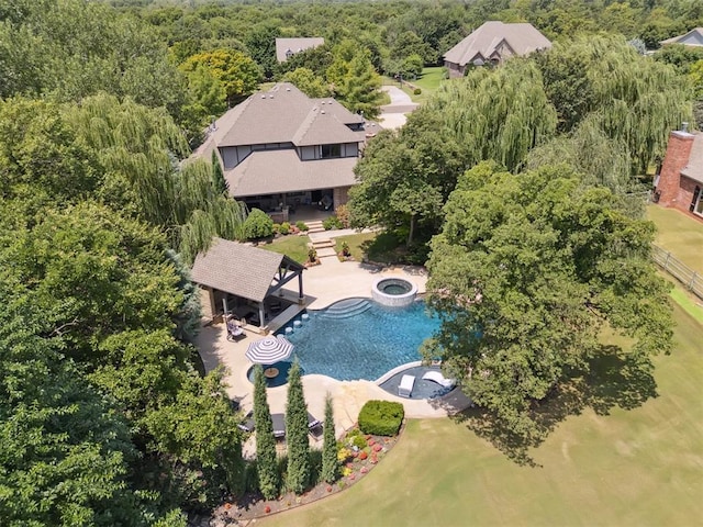 5710 Smoky Hill Trl, Edmond, OK 73034 - aerial view of property and surrounding area with a pool area and a heavily wooded area