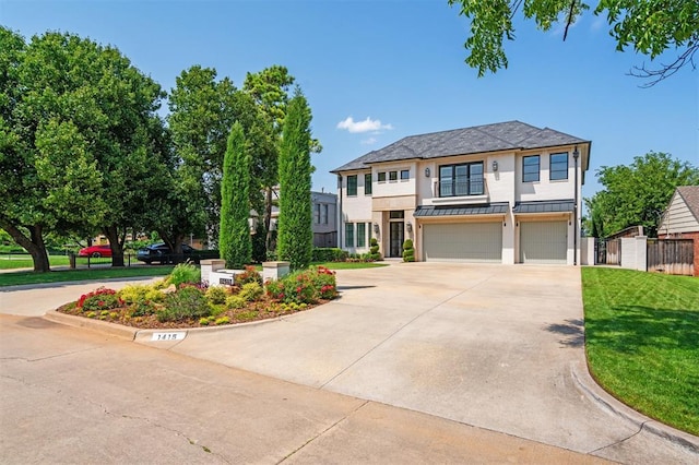 1415 Sherwood Ln, Nichols Hills, OK 73116 - view of front facade featuring a standing seam roof, driveway, an attached garage, stucco siding, and a metal roof