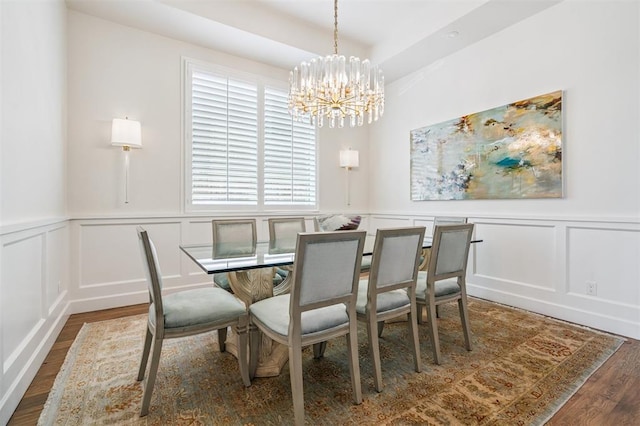 1415 Sherwood Ln, Nichols Hills, OK 73116 - dining room with a decorative wall, a chandelier, wood finished floors, and a wainscoted wall