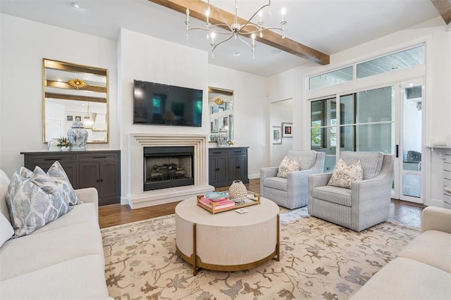 1415 Sherwood Ln, Nichols Hills, OK 73116 - living area with wood finished floors, a chandelier, beamed ceiling, and a fireplace with raised hearth