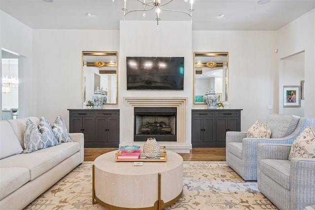 1415 Sherwood Ln, Nichols Hills, OK 73116 - living area featuring a chandelier, light wood finished floors, and a fireplace with raised hearth