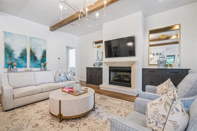 1415 Sherwood Ln, Nichols Hills, OK 73116 - living room featuring light wood-type flooring, a chandelier, beamed ceiling, and a fireplace with raised hearth