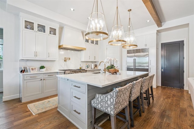 1415 Sherwood Ln, Nichols Hills, OK 73116 - kitchen featuring custom range hood, stainless steel appliances, a chandelier, white cabinets, and glass insert cabinets