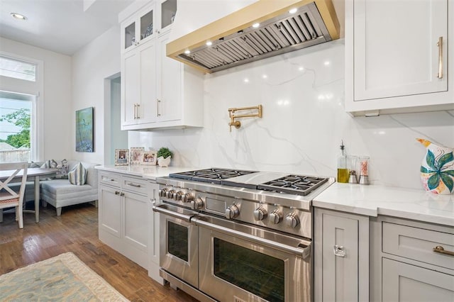 1415 Sherwood Ln, Nichols Hills, OK 73116 - kitchen featuring double oven range, custom exhaust hood, dark wood finished floors, backsplash, and glass insert cabinets