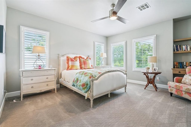 1415 Sherwood Ln, Nichols Hills, OK 73116 - bedroom with carpet floors, multiple windows, and ceiling fan