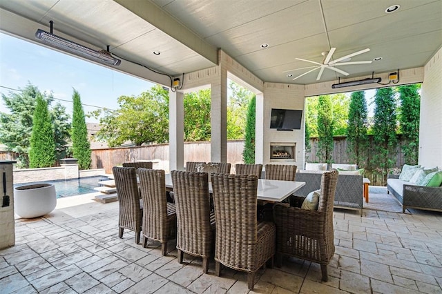 1415 Sherwood Ln, Nichols Hills, OK 73116 - fenced backyard with a patio, an outdoor living space with a fireplace, outdoor dining space, and a ceiling fan