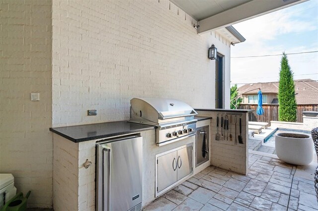 1415 Sherwood Ln, Nichols Hills, OK 73116 - view of patio / terrace with an outdoor kitchen