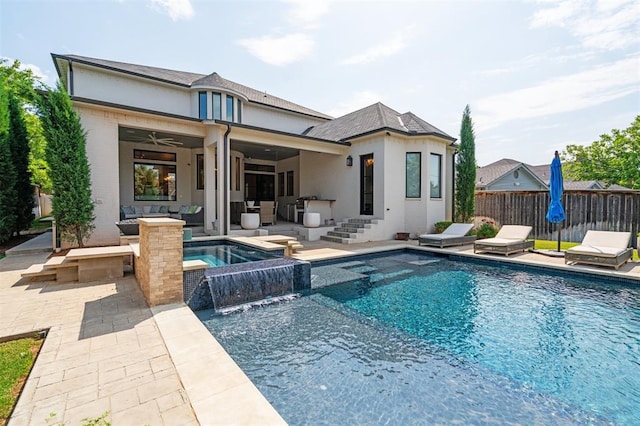 1415 Sherwood Ln, Nichols Hills, OK 73116 - rear view of property with an outdoor hangout area, a pool with connected hot tub, a patio area, a ceiling fan, and stucco siding