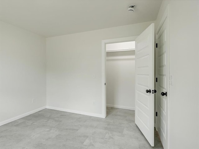 1609 NE 26th St, Oklahoma City, OK 73111 - unfurnished bedroom featuring a walk in closet and baseboards