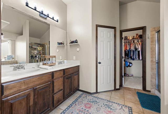 18200 Allora Dr, Edmond, OK 73012 - full bathroom featuring a stall shower, tile patterned flooring, double vanity, and a spacious closet