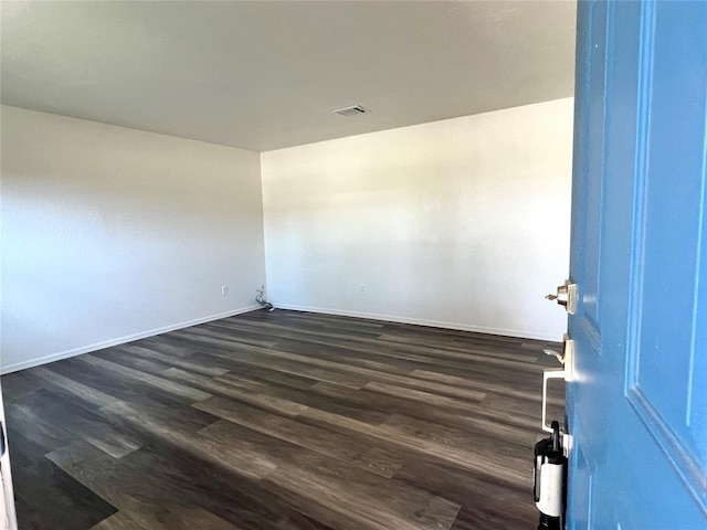 12519 SW 2nd St, Yukon, OK 73099 - spare room featuring dark wood-style flooring and baseboards