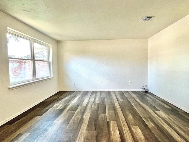 12519 SW 2nd St, Yukon, OK 73099 - spare room featuring baseboards and dark wood-style flooring