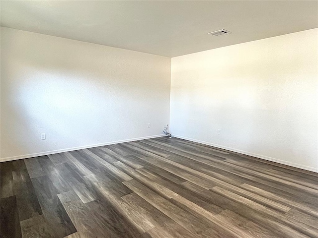 12519 SW 2nd St, Yukon, OK 73099 - unfurnished room with baseboards and dark wood-type flooring