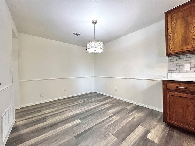 12519 SW 2nd St, Yukon, OK 73099 - unfurnished dining area with dark wood-style flooring and baseboards