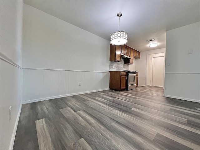 12519 SW 2nd St, Yukon, OK 73099 - kitchen with stainless steel range oven, dark wood finished floors, decorative light fixtures, light countertops, and open floor plan