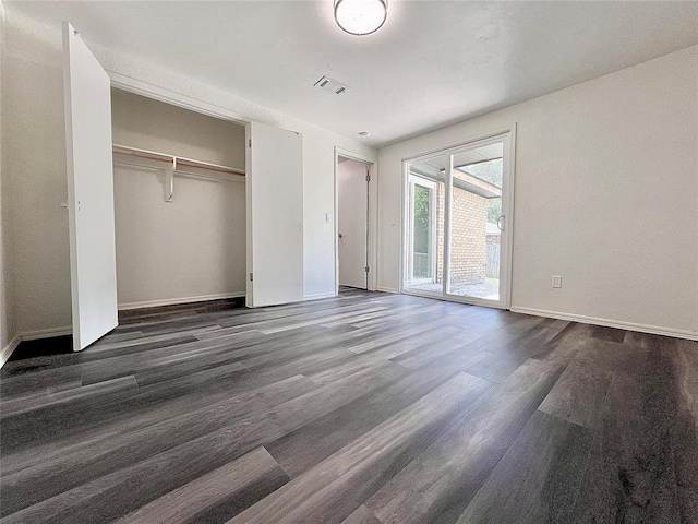 12519 SW 2nd St, Yukon, OK 73099 - unfurnished bedroom with dark wood-style flooring, access to exterior, and a closet