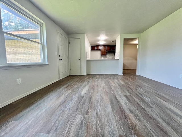 12517 SW 2nd St, Yukon, OK 73099 - unfurnished living room with dark wood-style flooring and baseboards