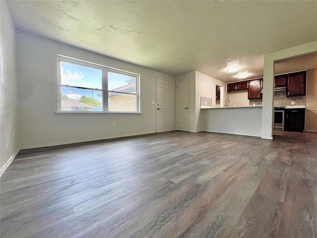 12517 SW 2nd St, Yukon, OK 73099 - unfurnished living room with dark wood-style floors and baseboards