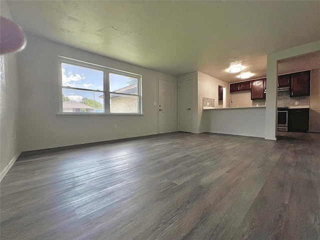 12517 SW 2nd St, Yukon, OK 73099 - unfurnished living room with dark wood-style flooring and baseboards