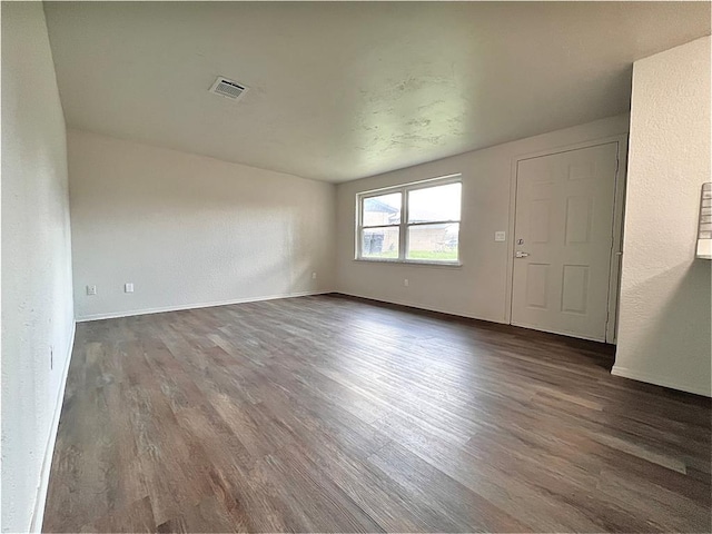 12517 SW 2nd St, Yukon, OK 73099 - unfurnished room featuring dark wood-style floors and baseboards