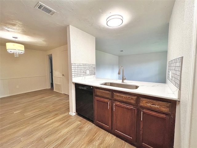12517 SW 2nd St, Yukon, OK 73099 - kitchen with dishwasher, light wood finished floors, a chandelier, decorative light fixtures, and light stone countertops