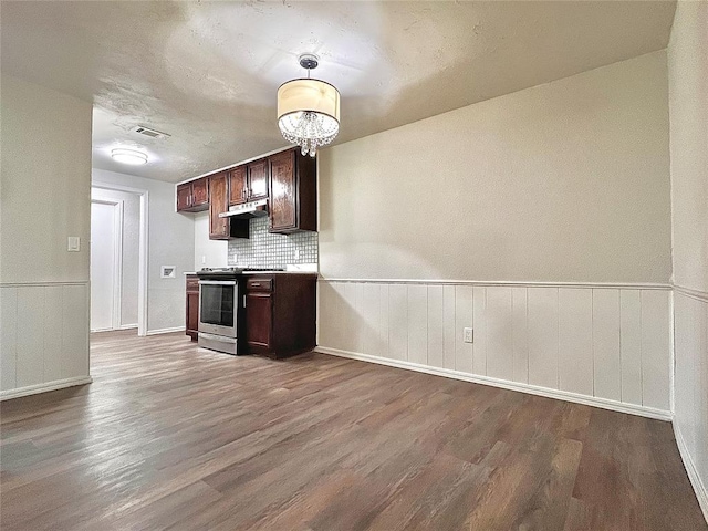 12517 SW 2nd St, Yukon, OK 73099 - kitchen featuring stainless steel electric range oven, wood finished floors, dark brown cabinets, under cabinet range hood, and a wainscoted wall