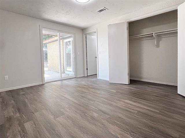12517 SW 2nd St, Yukon, OK 73099 - unfurnished bedroom with dark wood-style floors, access to outside, and a closet