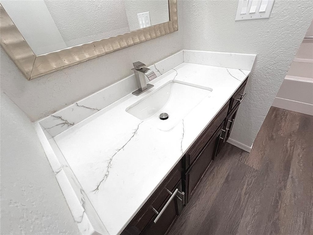 12517 SW 2nd St, Yukon, OK 73099 - bathroom with a textured wall, vanity, wood finished floors, and a textured ceiling