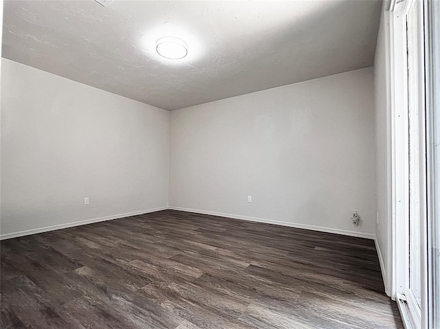12517 SW 2nd St, Yukon, OK 73099 - spare room with dark wood-style flooring and baseboards