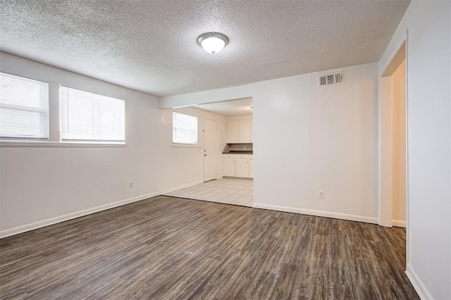 4025 Parkwoods Ln, Midwest City, OK 73110 - unfurnished room with wood finished floors and a textured ceiling