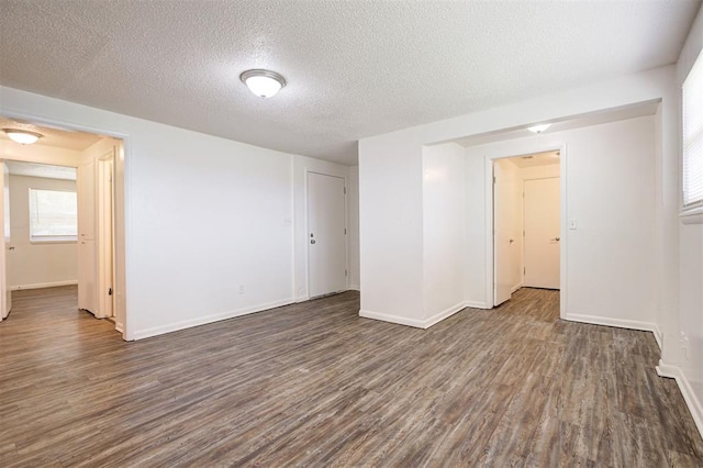 4025 Parkwoods Ln, Midwest City, OK 73110 - empty room with dark wood-type flooring and a textured ceiling