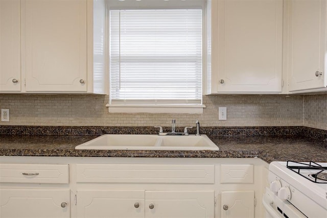 4025 Parkwoods Ln, Midwest City, OK 73110 - kitchen with dark countertops, white cabinets, and backsplash