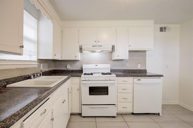 4025 Parkwoods Ln, Midwest City, OK 73110 - kitchen with white appliances, under cabinet range hood, decorative backsplash, and dark countertops