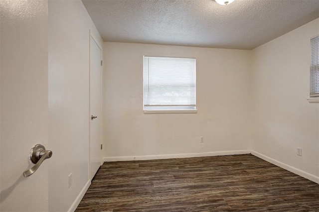 4025 Parkwoods Ln, Midwest City, OK 73110 - spare room with a textured ceiling and dark wood-type flooring