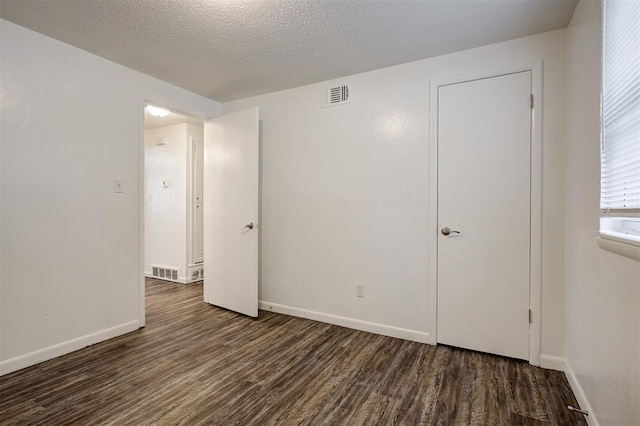4025 Parkwoods Ln, Midwest City, OK 73110 - spare room featuring wood finished floors and a textured ceiling