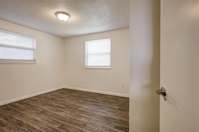 4025 Parkwoods Ln, Midwest City, OK 73110 - unfurnished room featuring a textured ceiling, plenty of natural light, and dark wood-style floors