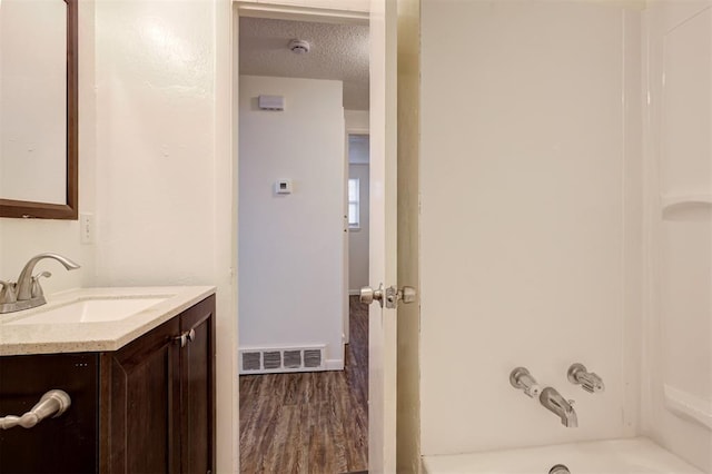 4025 Parkwoods Ln, Midwest City, OK 73110 - full bathroom with vanity, wood finished floors, and shower / tub combination